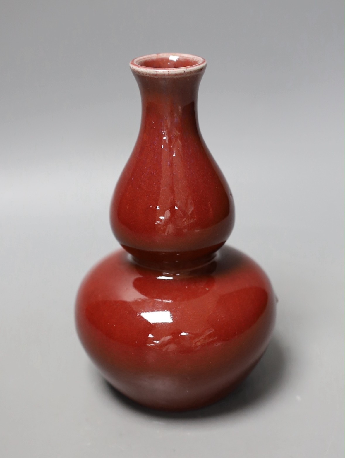 A Chinese sang de boeuf glazed double gourd vase, 18cm